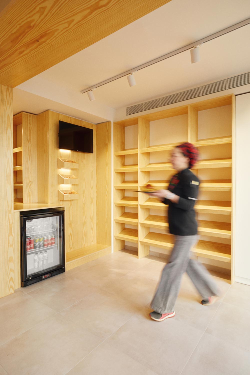 Brunch shop interior, view of the retail area with floor-to-ceiling wooden shelfs