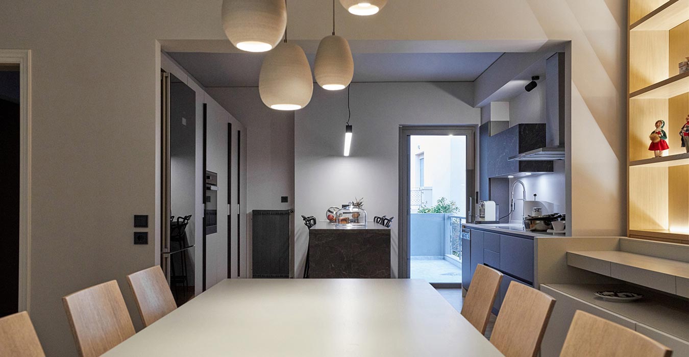 Open plan dining room and grey modern kitchen design.