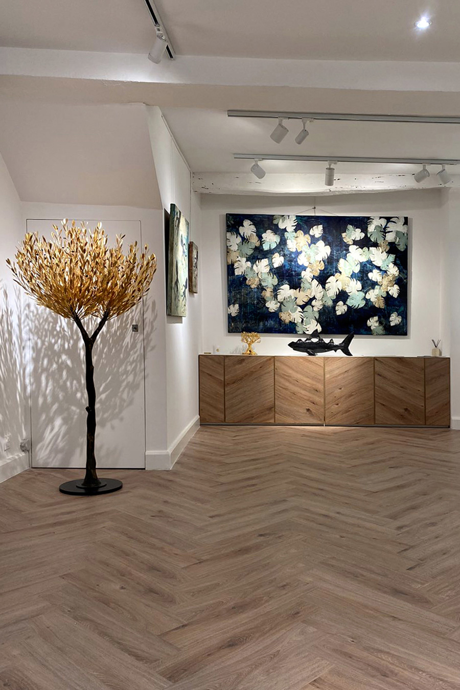 The herringbone flooring is placed horizontally and vertically in cupboards.