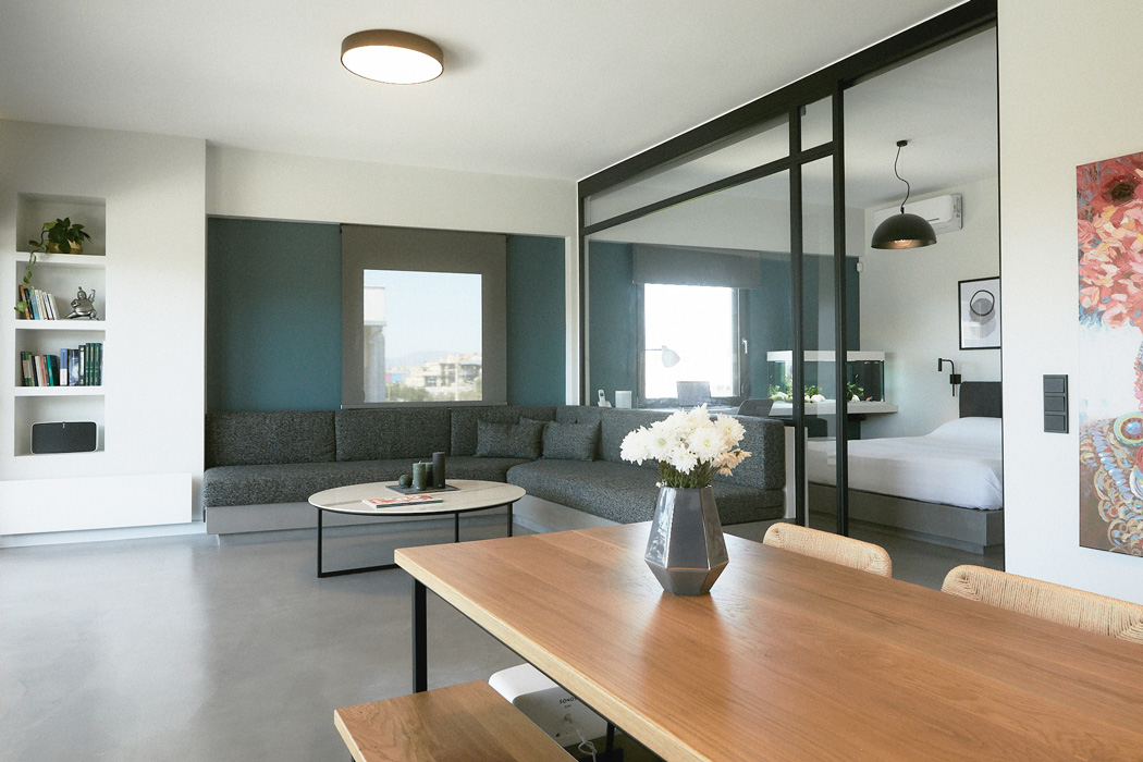 Modern glass partition between bedroom and living room.