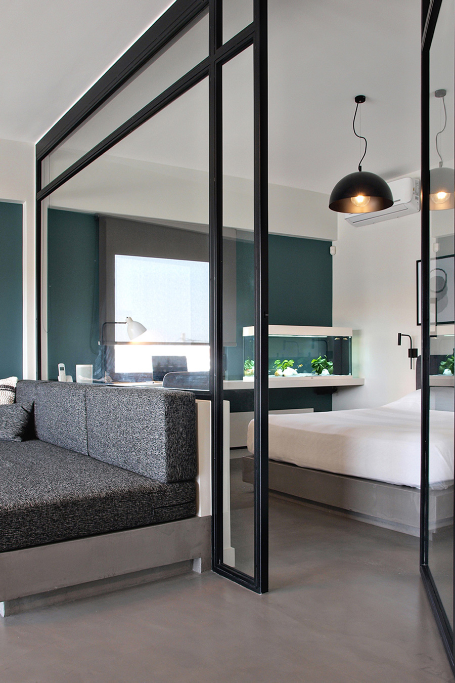 Modern glass partition between bedroom and living room.