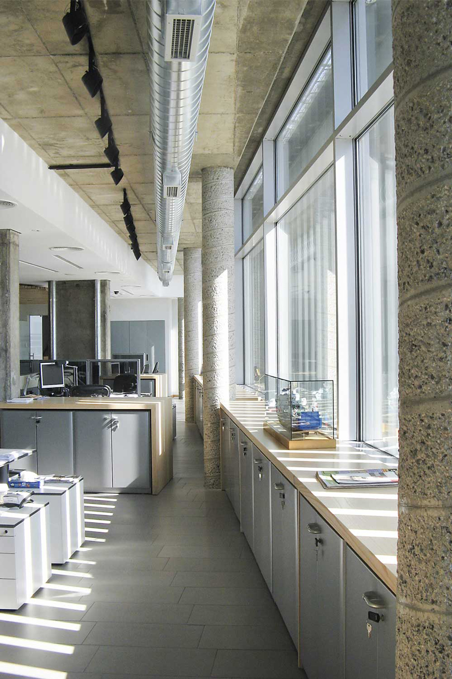 Central staircase with famous art work and architectural suspension lamps